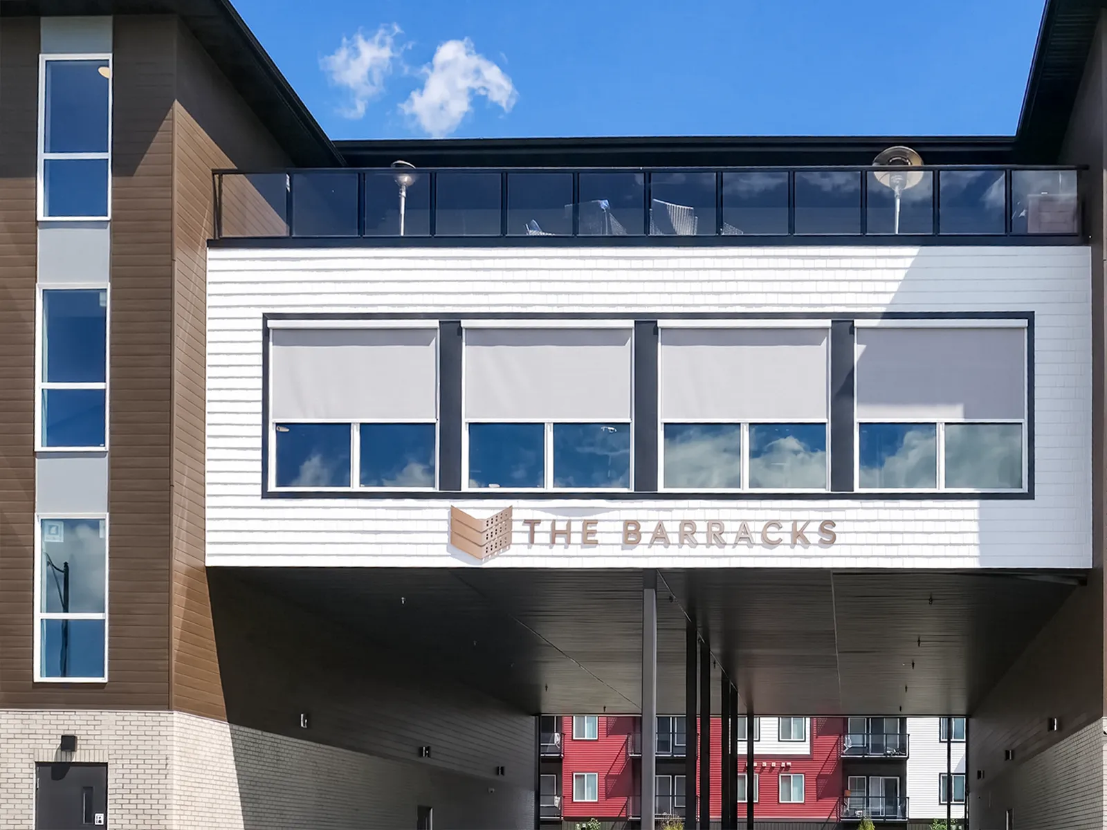 The Barracks exterior signage with shaded lounge windows