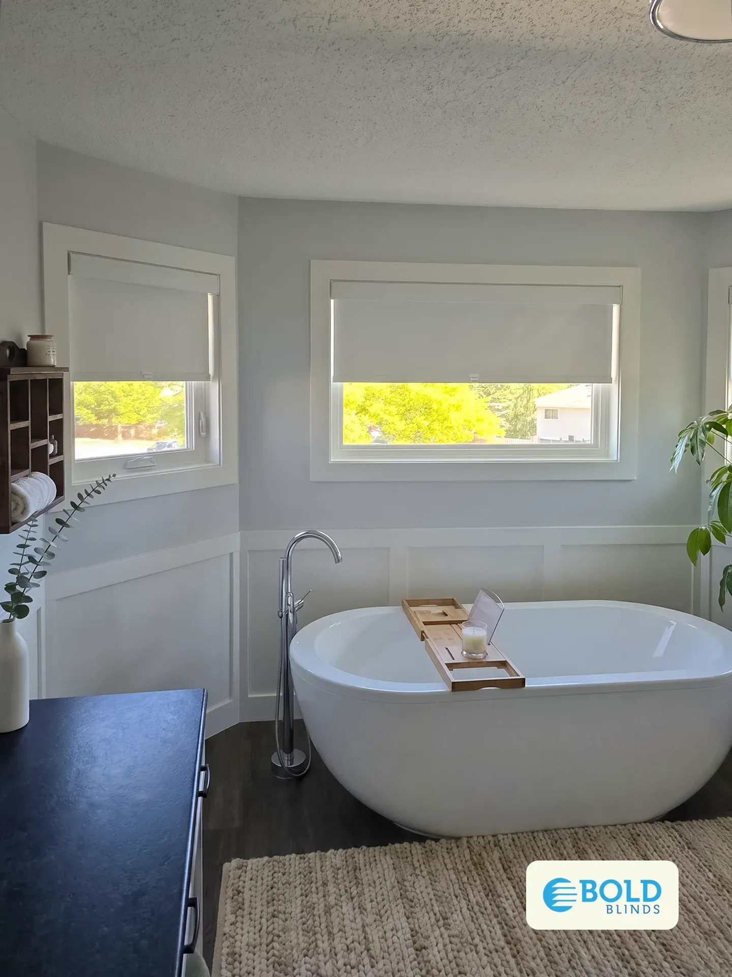 White roller shades above a freestanding tub in a Sherwood Park ensuite bathroom